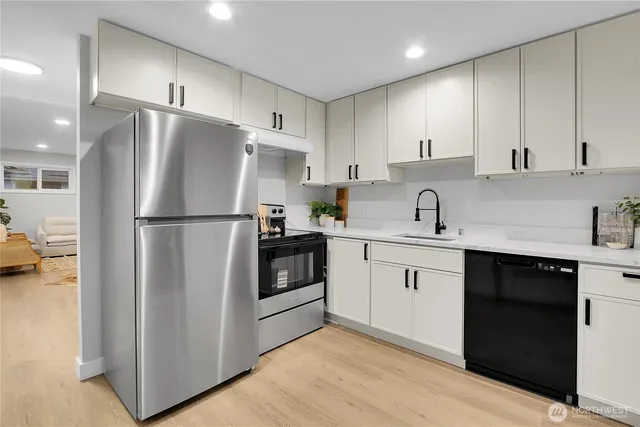 a kitchen with a refrigerator sink and cabinets