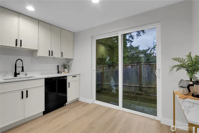 a kitchen with a sink and refrigerator
