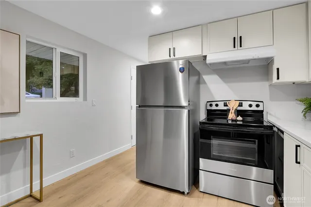 a kitchen with cabinets and stainless steel appliances