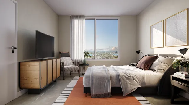 a bedroom with a bed and flat screen tv