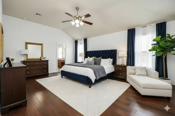 a bedroom with a large bed and a couch