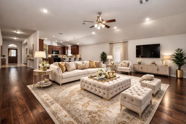 a living room with furniture kitchen view and a flat screen tv