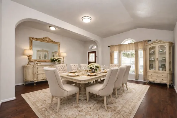 a view of a dining room with furniture and wooden floor