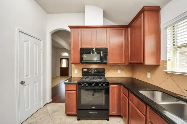 a kitchen with a refrigerator and a sink