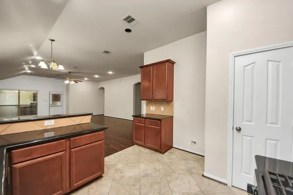 a kitchen with granite countertop cabinets and steel stainless steel appliances