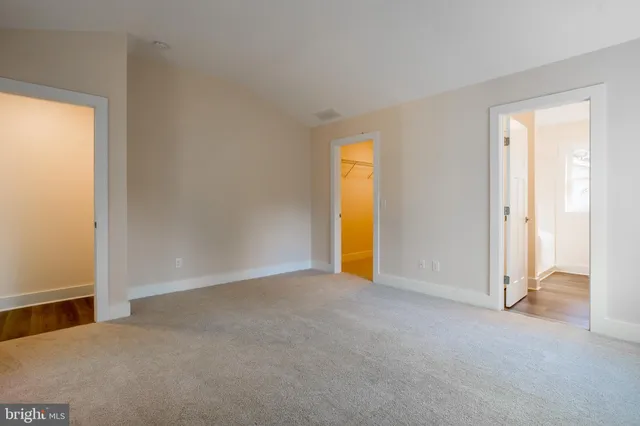 a view of an empty room and a window