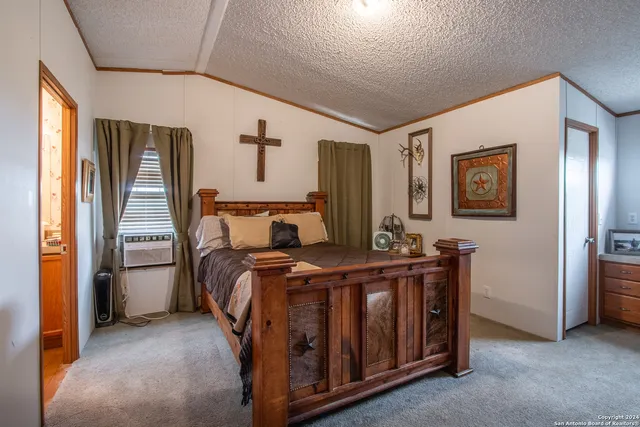 a bedroom with a bed and dresser