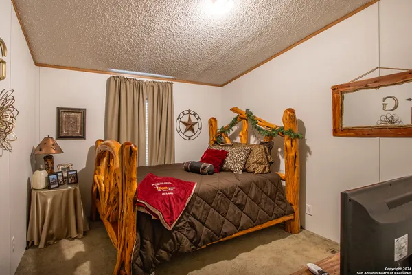 a kitchen with stainless steel appliances granite countertop a refrigerator a sink dishwasher a stove and white countertops with wooden floor