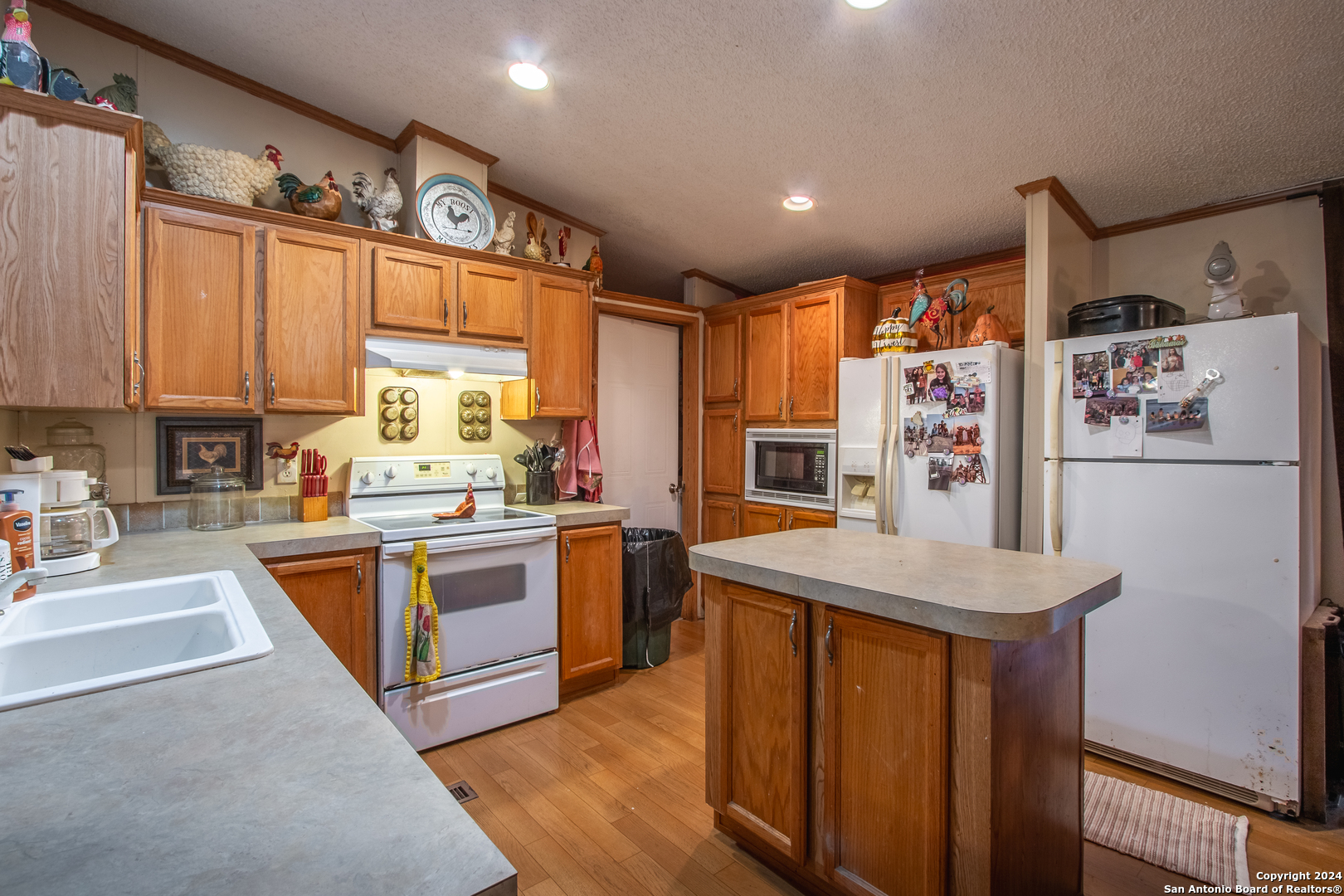 Tbd Ward Ranch Road Comstock, TX 78837 - Photo 5 of 20 a kitchen with stainless steel appliances granite countertop a refrigerator a sink dishwasher a stove and white countertops with wooden floor