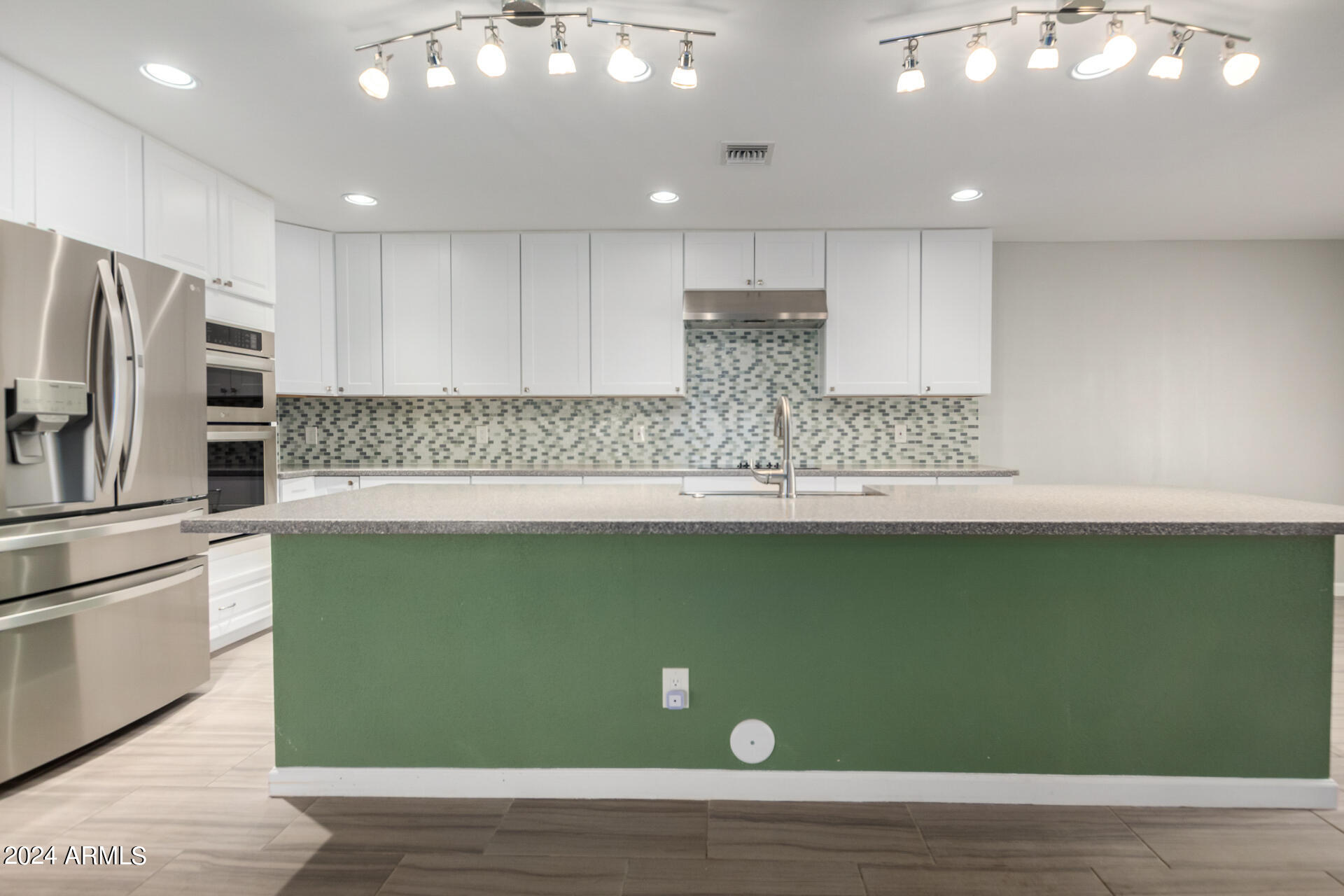 3216 West Hearn Road Phoenix, AZ 85053 - Photo 2 of 32 a kitchen with a refrigerator and a sink