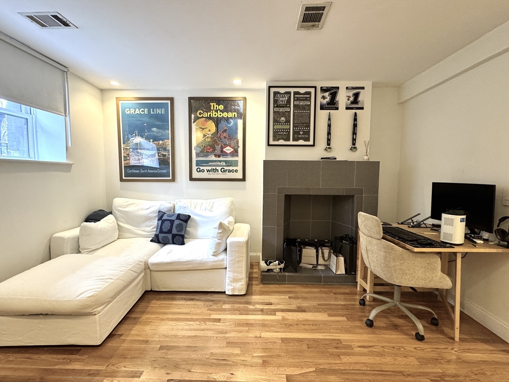 124 Beacon Street, Unit GF Boston, MA 02116 - Photo 1 of 11 a living room with furniture and a fireplace