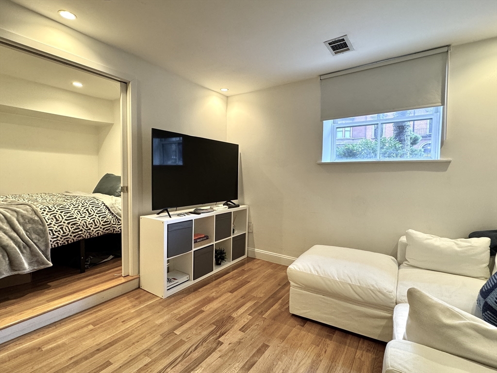 124 Beacon Street, Unit GF Boston, MA 02116 - Photo 3 of 11 a living room with furniture and a flat screen tv