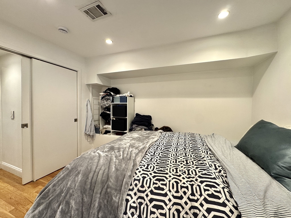 124 Beacon Street, Unit GF Boston, MA 02116 - Photo 4 of 11 a bedroom with a bed and a walk in closet