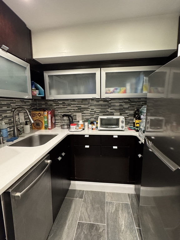 124 Beacon Street, Unit GF Boston, MA 02116 - Photo 8 of 11 a kitchen with a sink a stove and cabinets