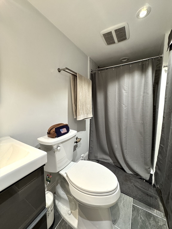 124 Beacon Street, Unit GF Boston, MA 02116 - Photo 9 of 11 a white toilet sitting next to a bathroom sink