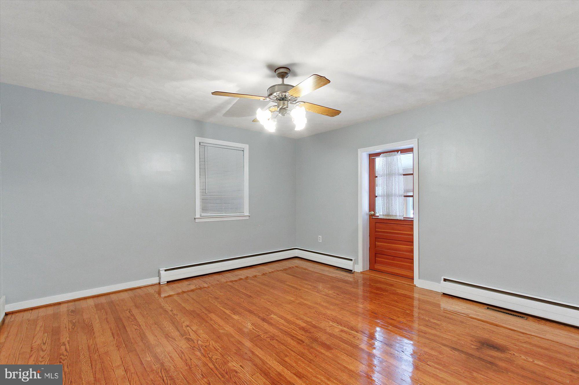 222 Dew Drop Road York, PA 17402 - Photo 13 of 31 a view of empty room with wooden floor and fan