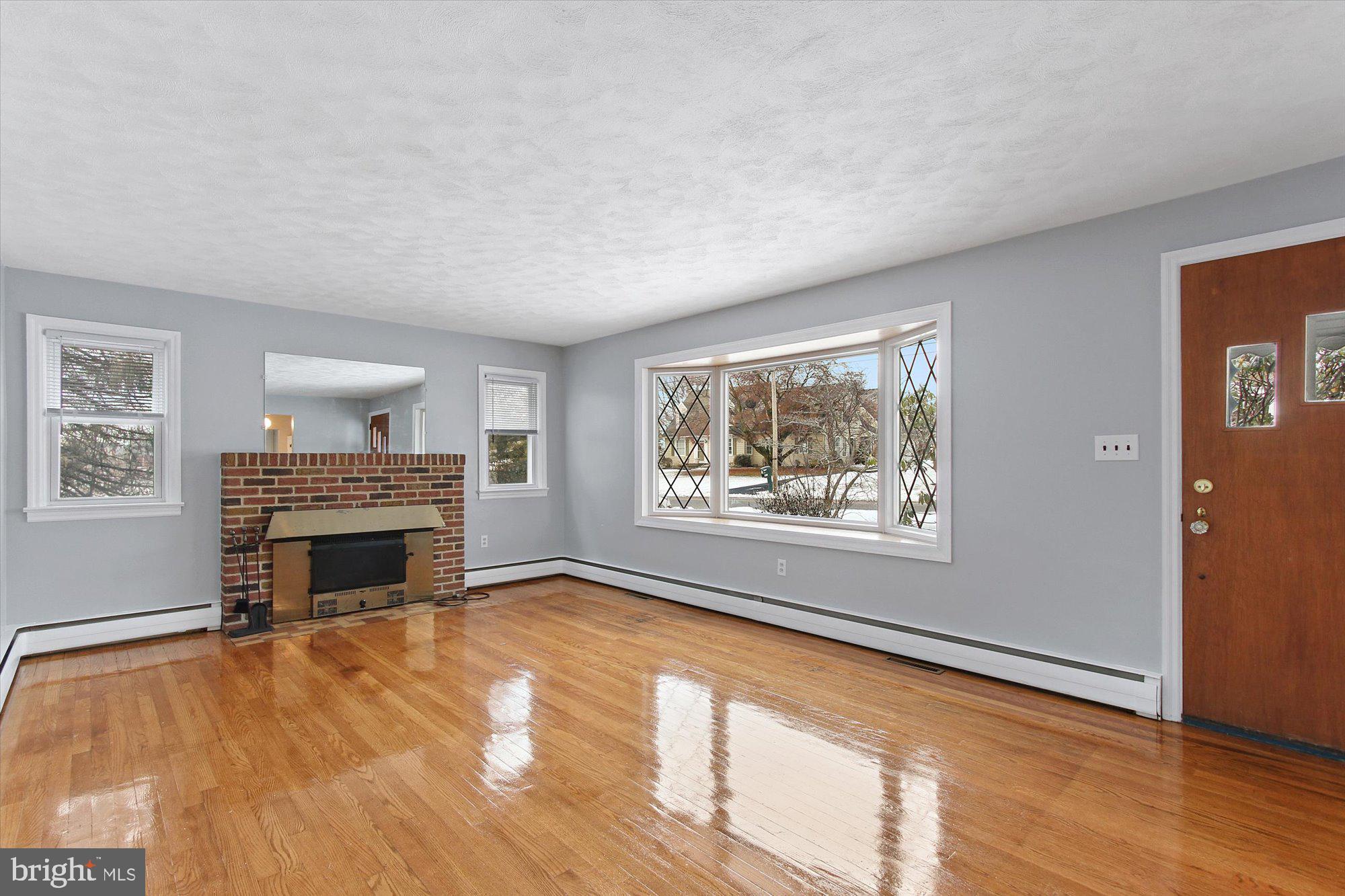 222 Dew Drop Road York, PA 17402 - Photo 4 of 31 wooden floor fireplace and windows in an empty room