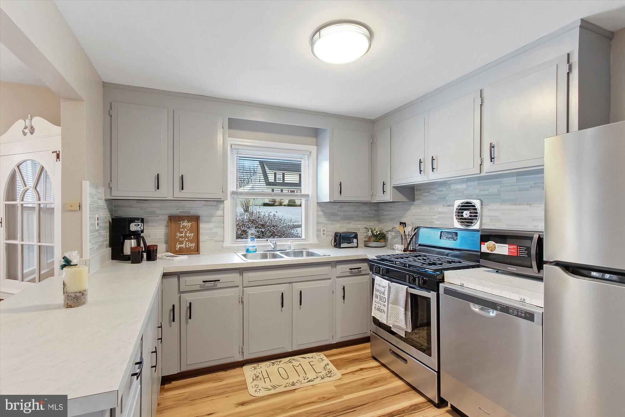 222 Dew Drop Road York, PA 17402 - Photo 7 of 31 a kitchen with stainless steel appliances granite countertop a sink stove and refrigerator