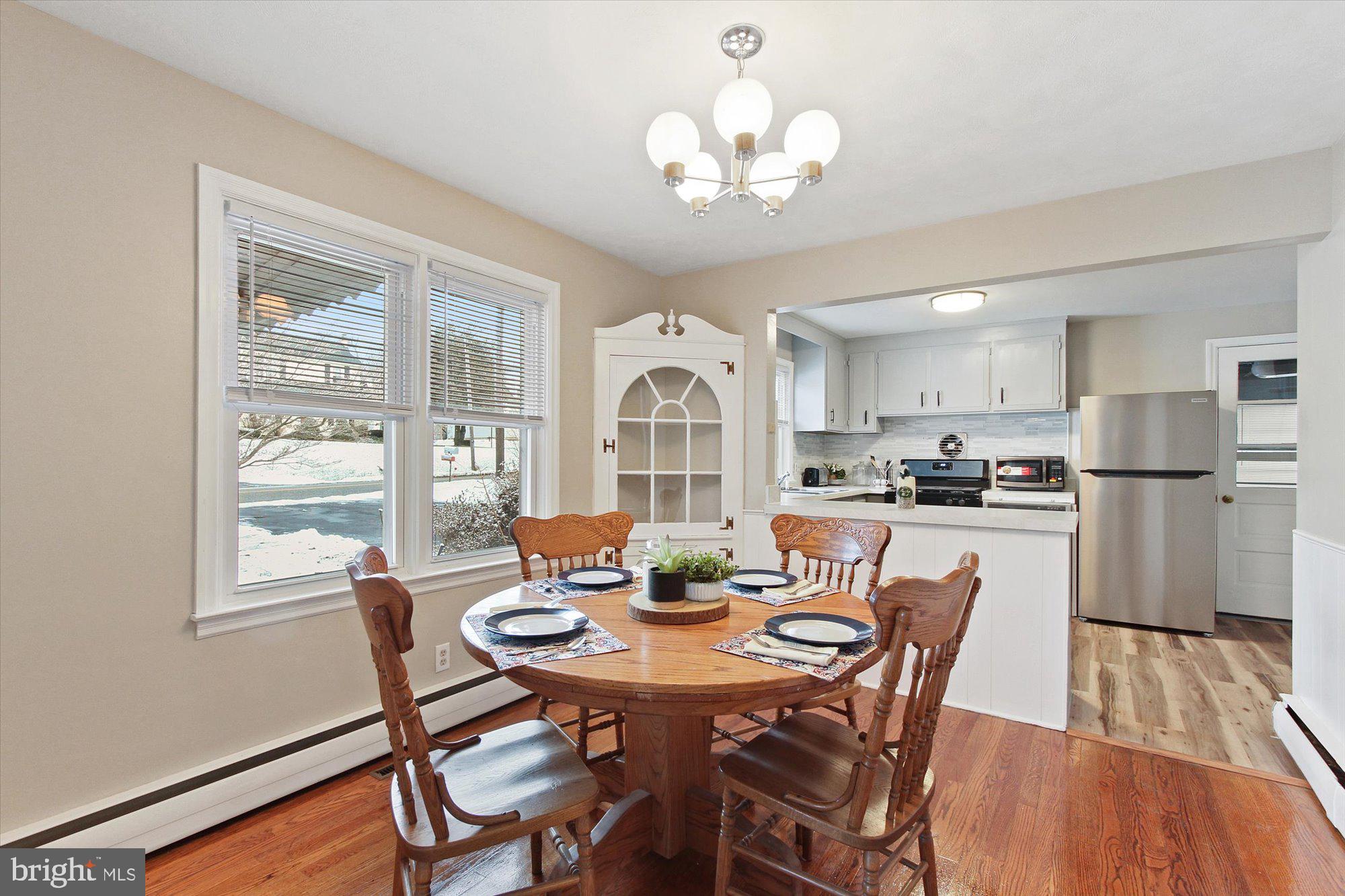 222 Dew Drop Road York, PA 17402 - Photo 8 of 31 a view of a dining room with furniture a chandelier and wooden floor