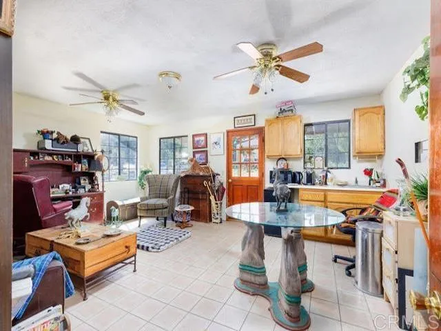 a living room with patio furniture and a large window