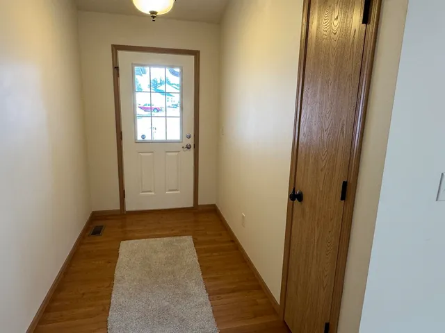 a view of a hallway with wooden floor