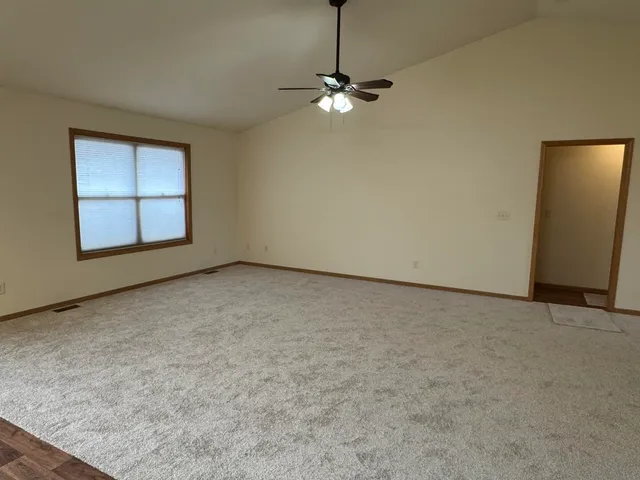 a view of an empty room with a window