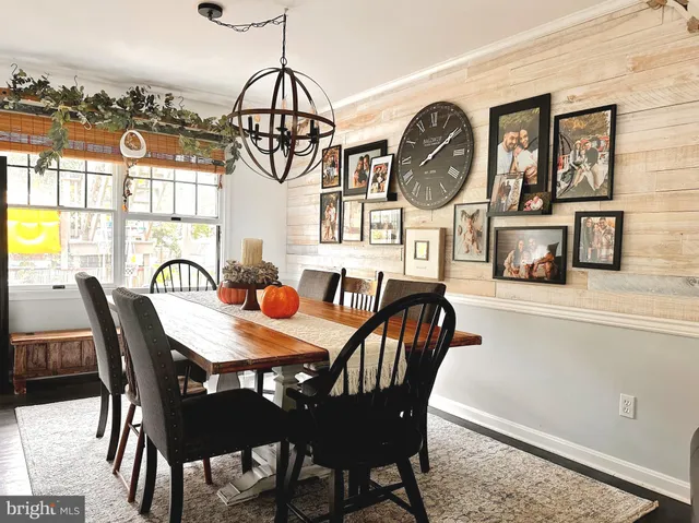 a view of a dining room with furniture and chandelier