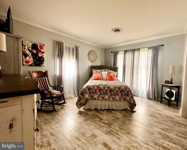 a bedroom with furniture and a window