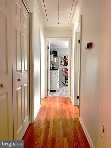 a view of a hallway view with wooden floor and closet