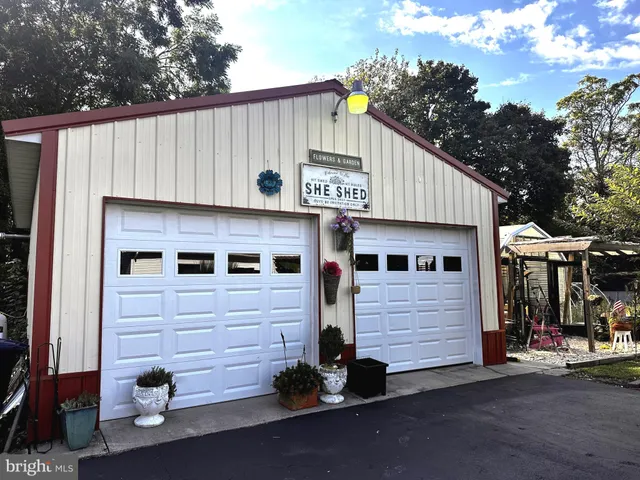a view of a small house and a garage