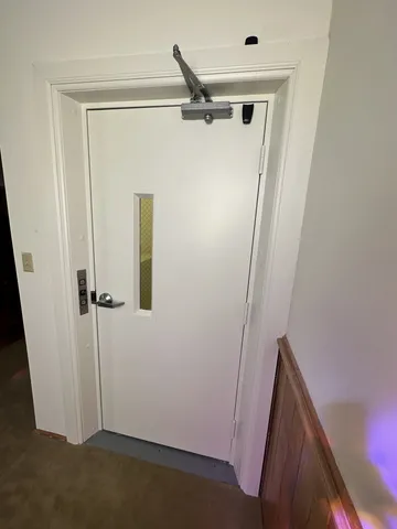 a view of a hallway with wooden floor