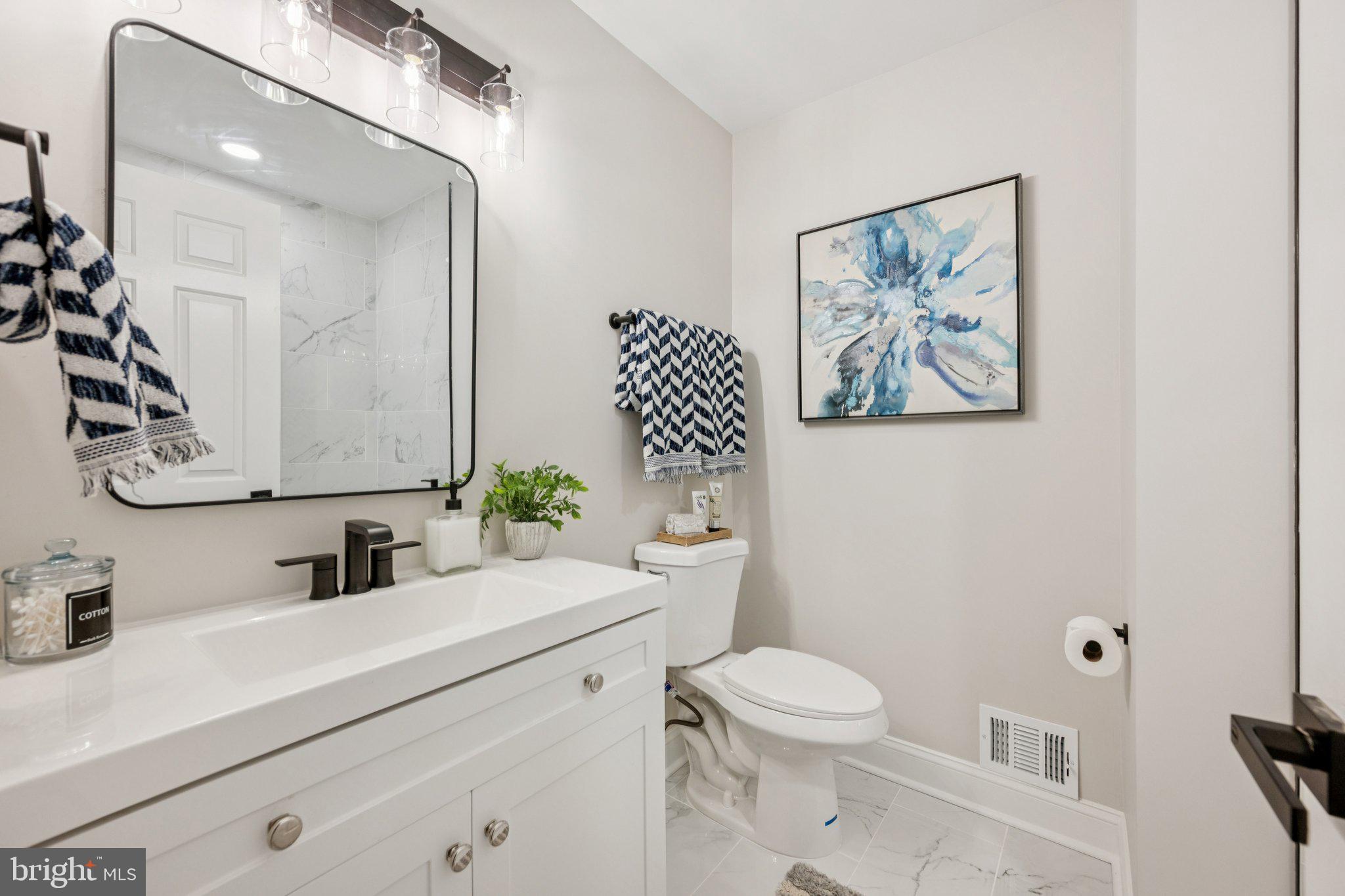 5144 Westpath Way Bethesda, MD 20816 - Photo 26 of 42 a bathroom with a toilet a sink and mirror