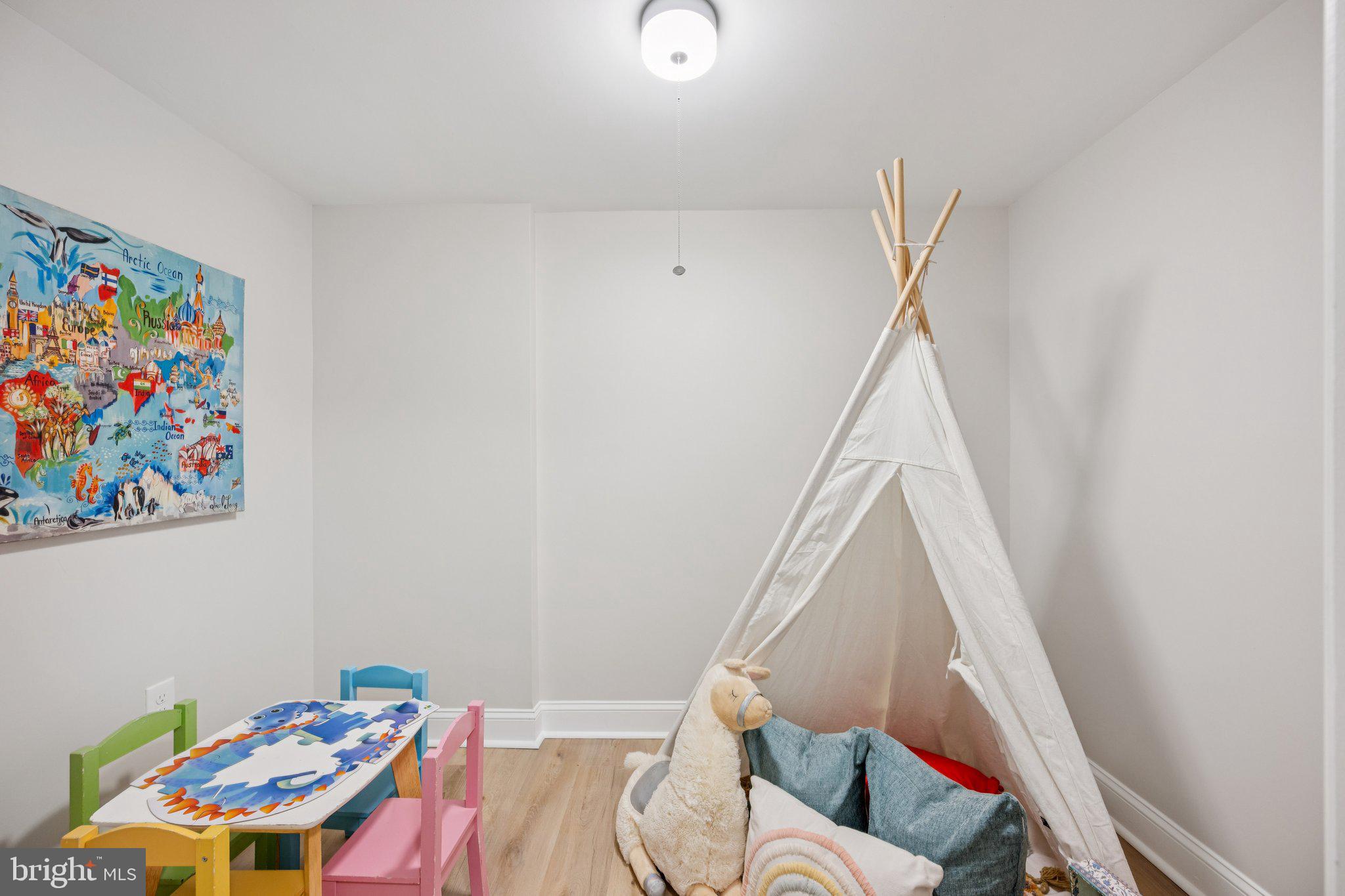 5144 Westpath Way Bethesda, MD 20816 - Photo 33 of 42 a living room with furniture and a baby crib