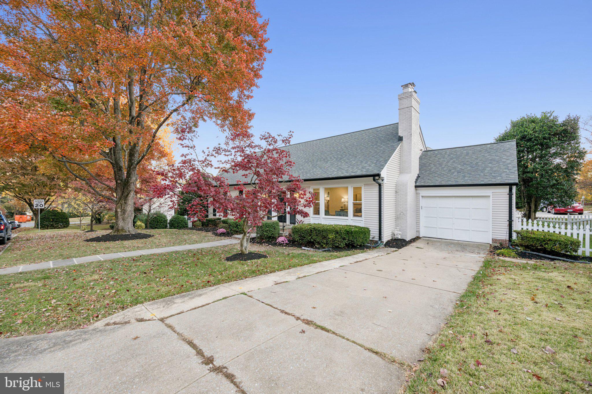5144 Westpath Way Bethesda, MD 20816 - Photo 5 of 42 a front view of a house with a yard and garage