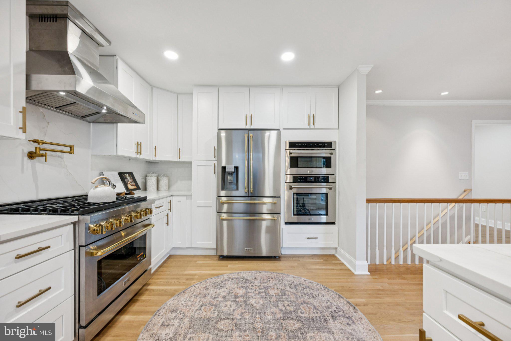 5144 Westpath Way Bethesda, MD 20816 - Photo 7 of 42 a kitchen with stainless steel appliances granite countertop a stove and a refrigerator