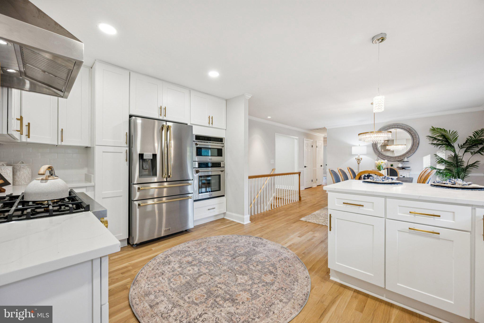 5144 Westpath Way Bethesda, MD 20816 - Photo 8 of 42 a kitchen with a refrigerator and a stove top oven