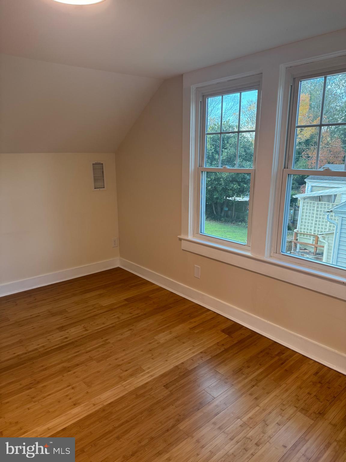 902 Cedar Street Pocomoke City, MD 21851 - Photo 19 of 27 a view of an empty room with wooden floor and a window