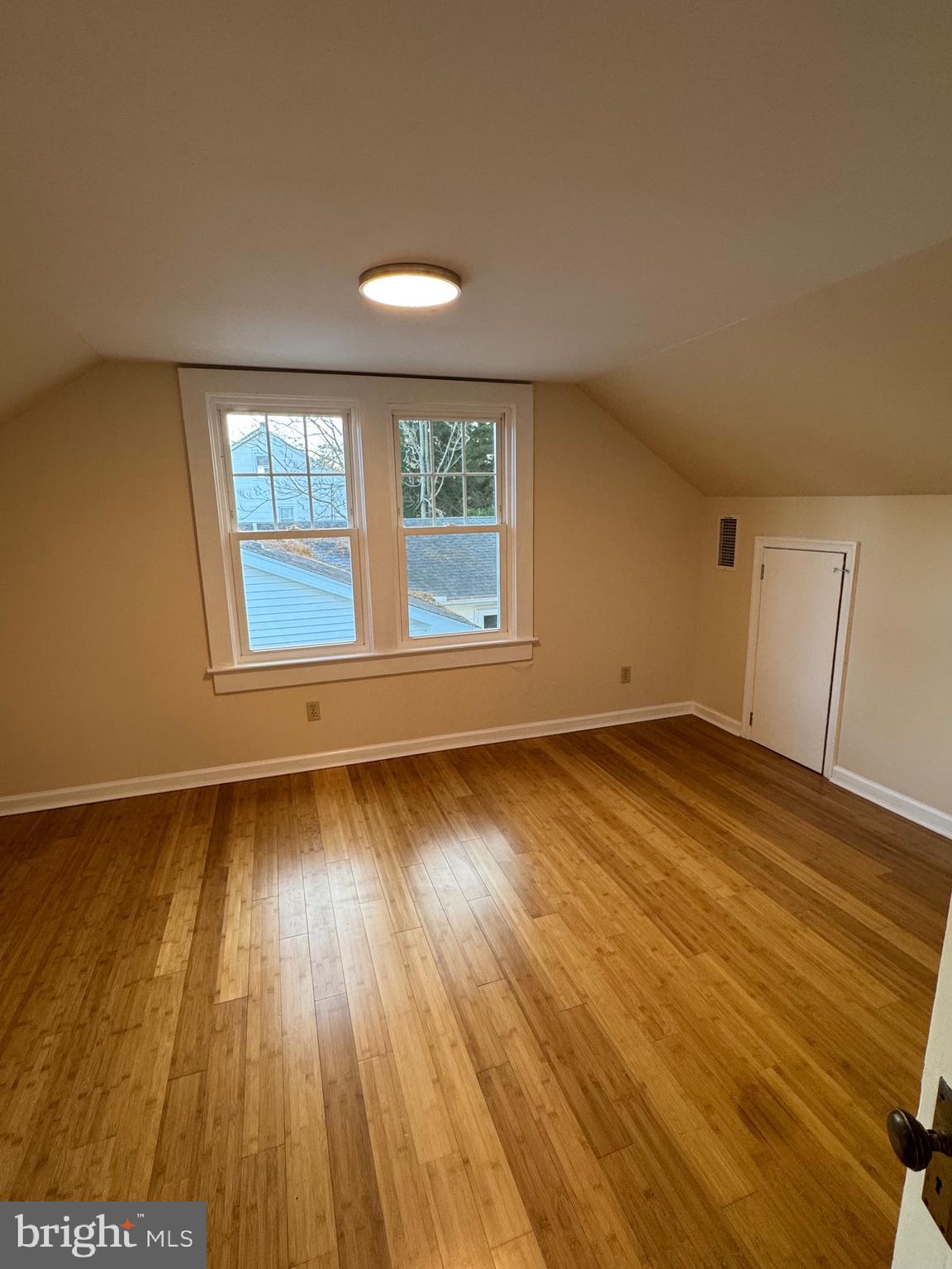 902 Cedar Street Pocomoke City, MD 21851 - Photo 21 of 27 an empty room with wooden floor and windows