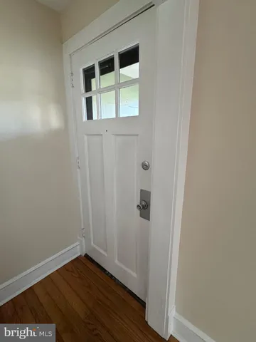 a view of front door with wooden floor