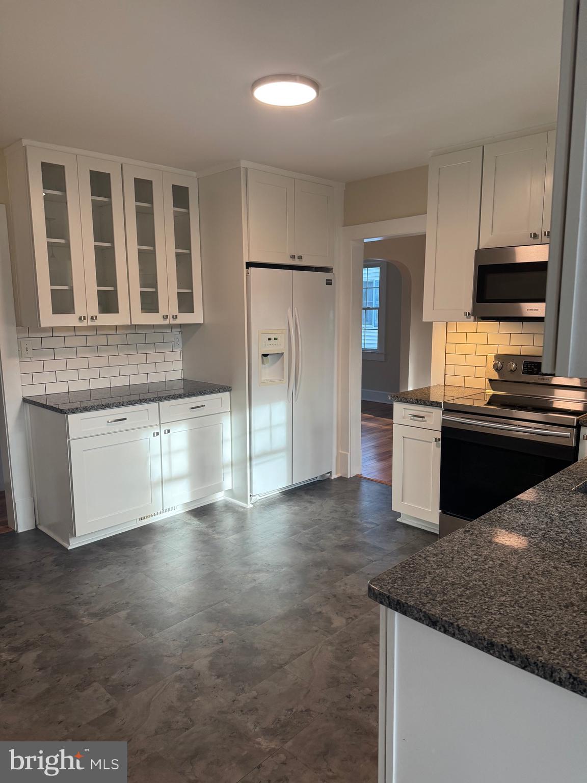 902 Cedar Street Pocomoke City, MD 21851 - Photo 9 of 27 a kitchen with stainless steel appliances granite countertop a stove a sink and a microwave