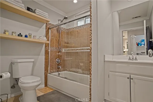 a bathroom with a bathtub shower sink vanity and toilet