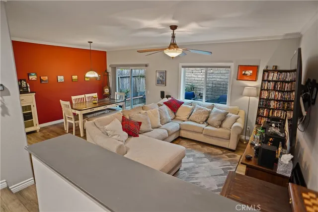 a living room with furniture a chandelier and a flat screen tv