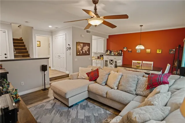a living room with furniture and a ceiling fan