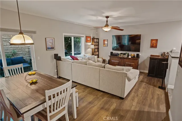 a living room with furniture a flat screen tv and a chandelier