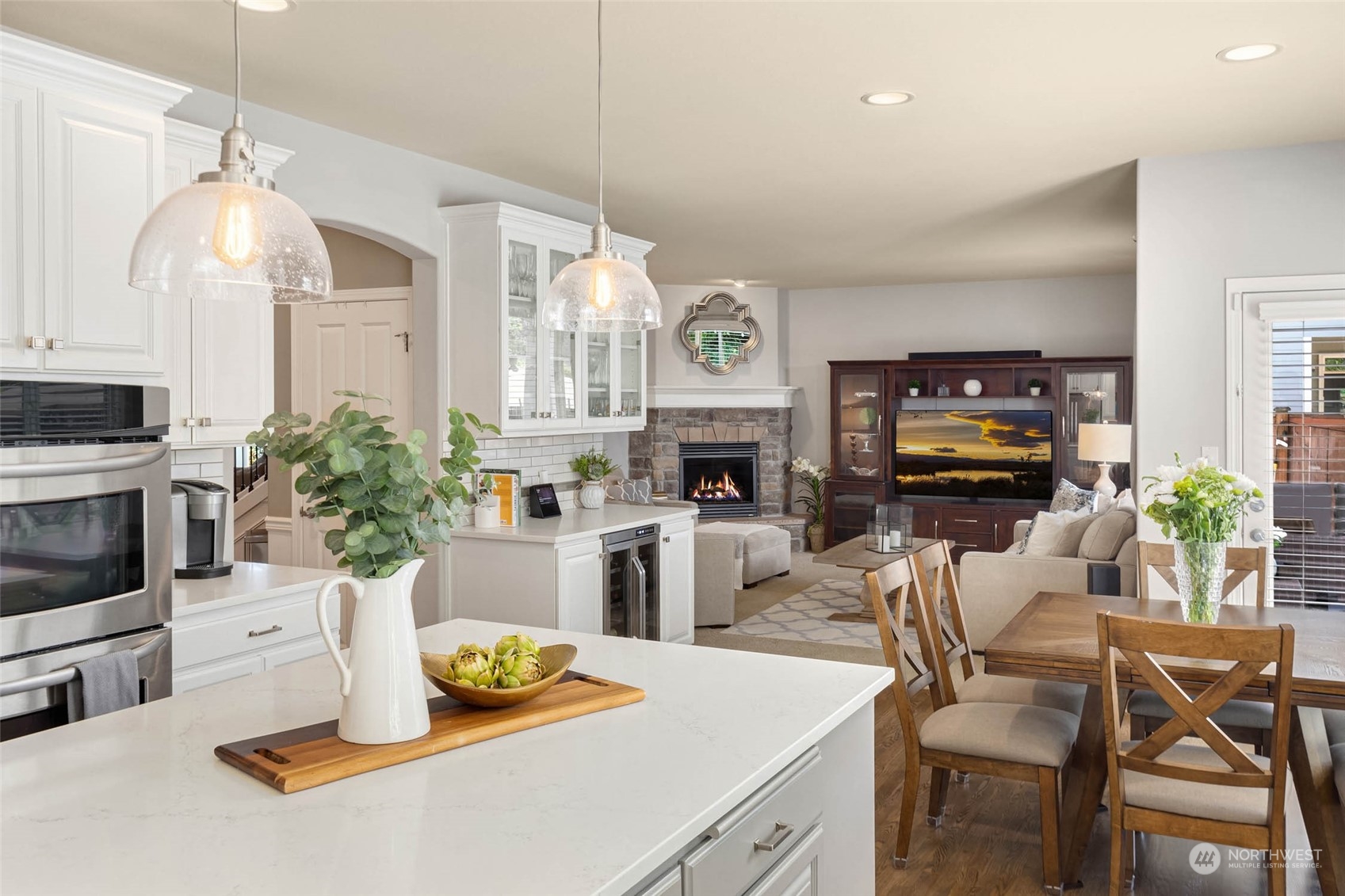 3608 214th Place Southeast Bothell, WA 98021 - Photo 14 of 37 a kitchen with stainless steel appliances kitchen island granite countertop a stove a sink a microwave a dining table and chairs
