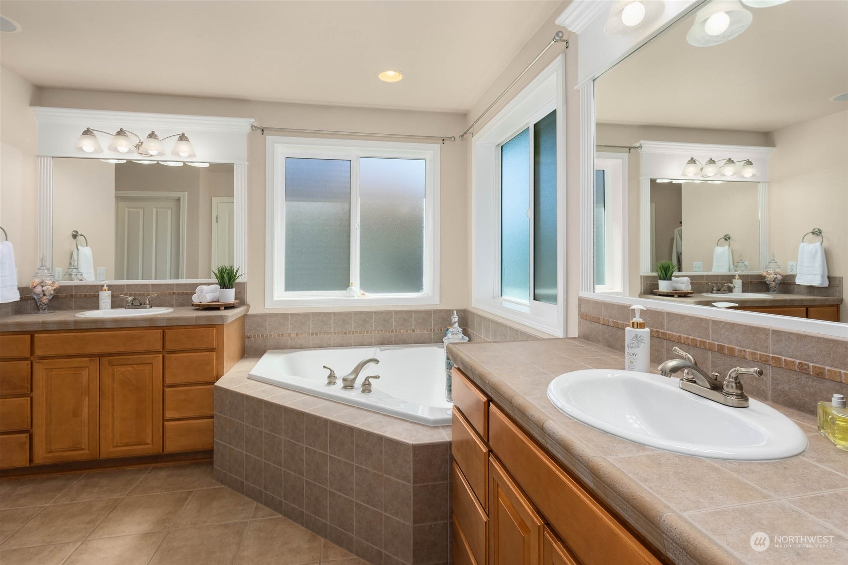 3608 214th Place Southeast Bothell, WA 98021 - Photo 26 of 37 a bathroom with a sink double vanity granite tub shower and a mirror
