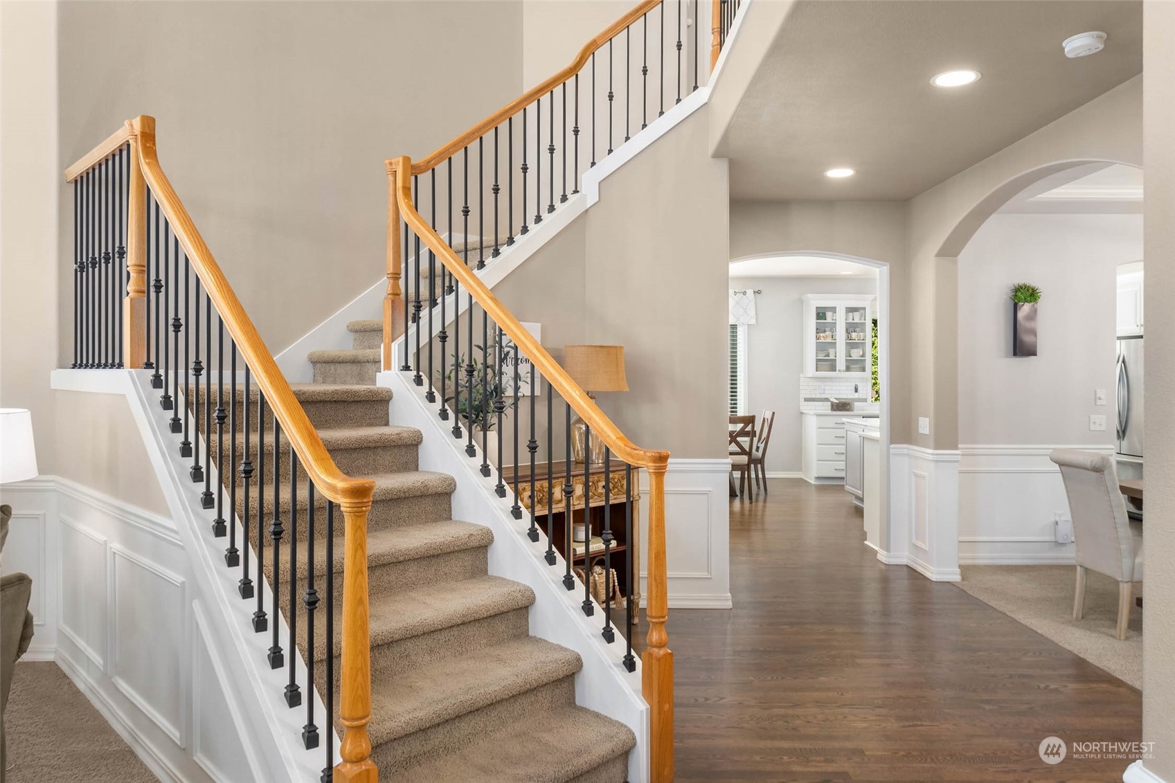 3608 214th Place Southeast Bothell, WA 98021 - Photo 4 of 37 a view of staircase with lots of frames on wall and wooden floor