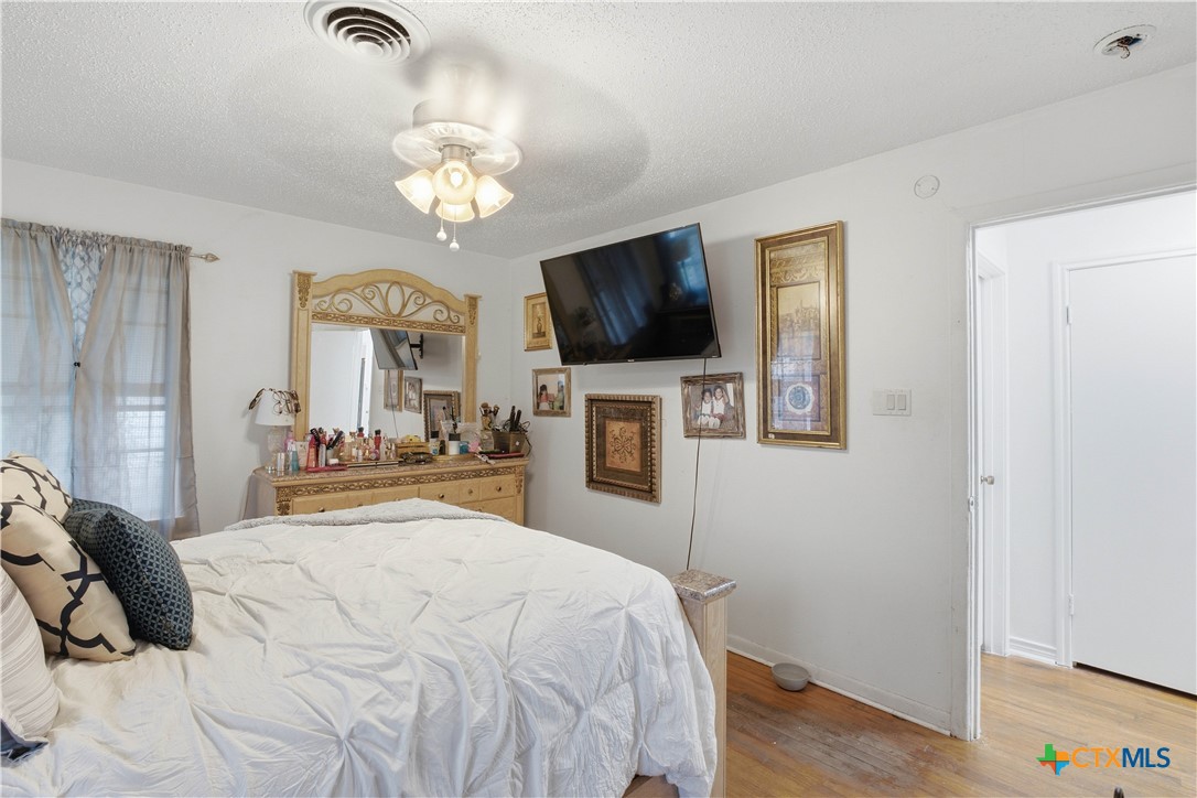503 Cardinal Avenue Killeen, TX 76541 - Photo 21 of 26 a bedroom with a bed and a flat tv screen on dresser
