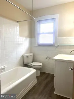 a bathroom with a bathtub and a sink