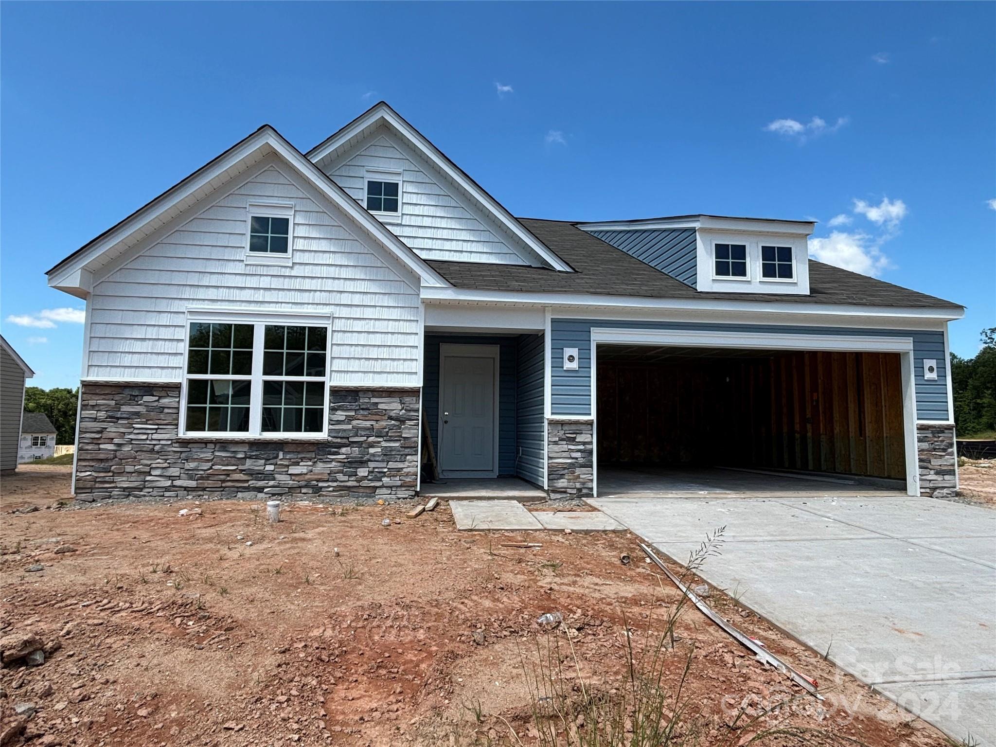 641 Mile Crk Road, Unit 72 Edgemoor, SC 29712 - Photo 1 of 16 a front view of a house with large windows and a yard